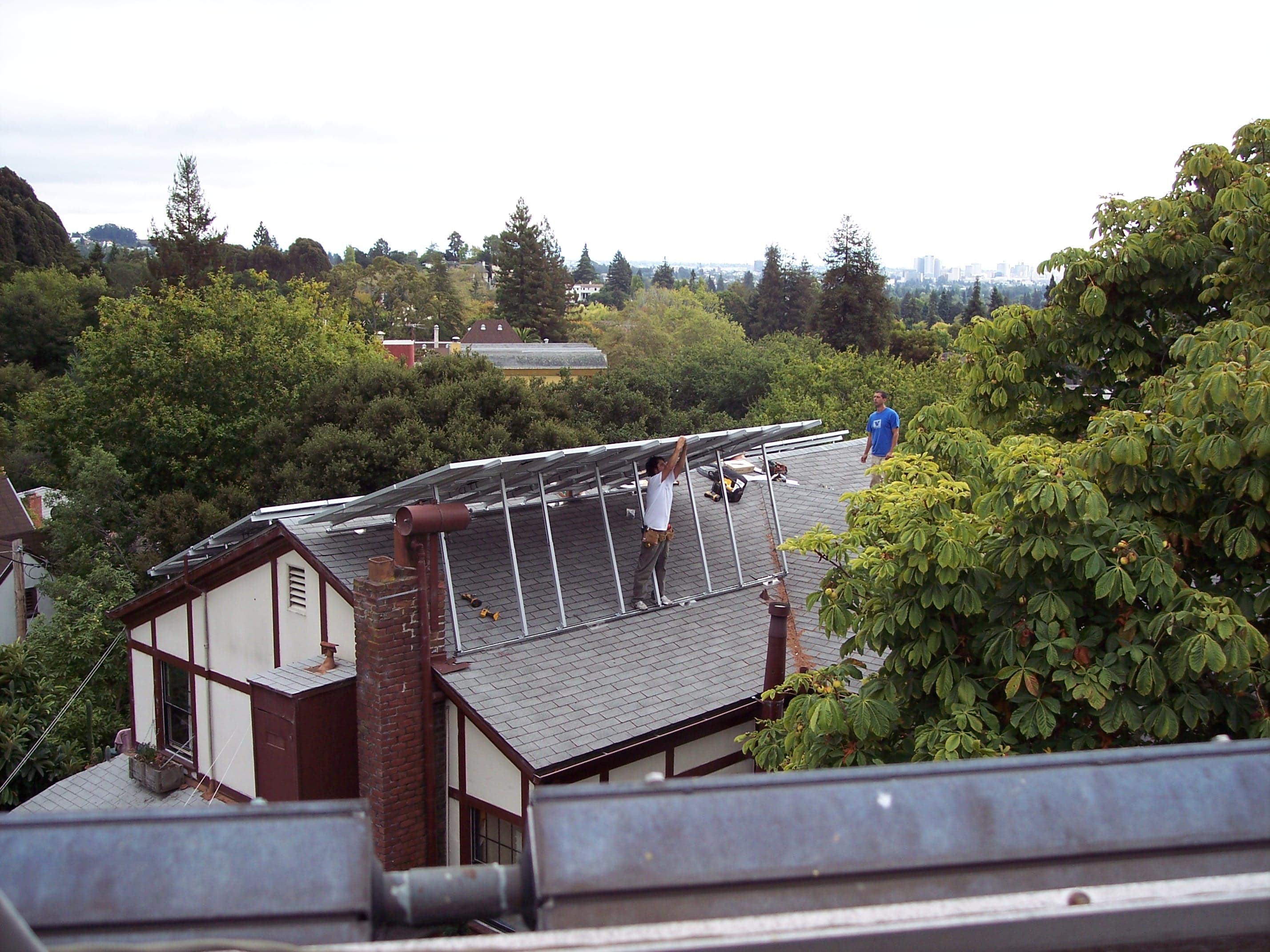 Installer securing rooftop solar panel mounting hardware