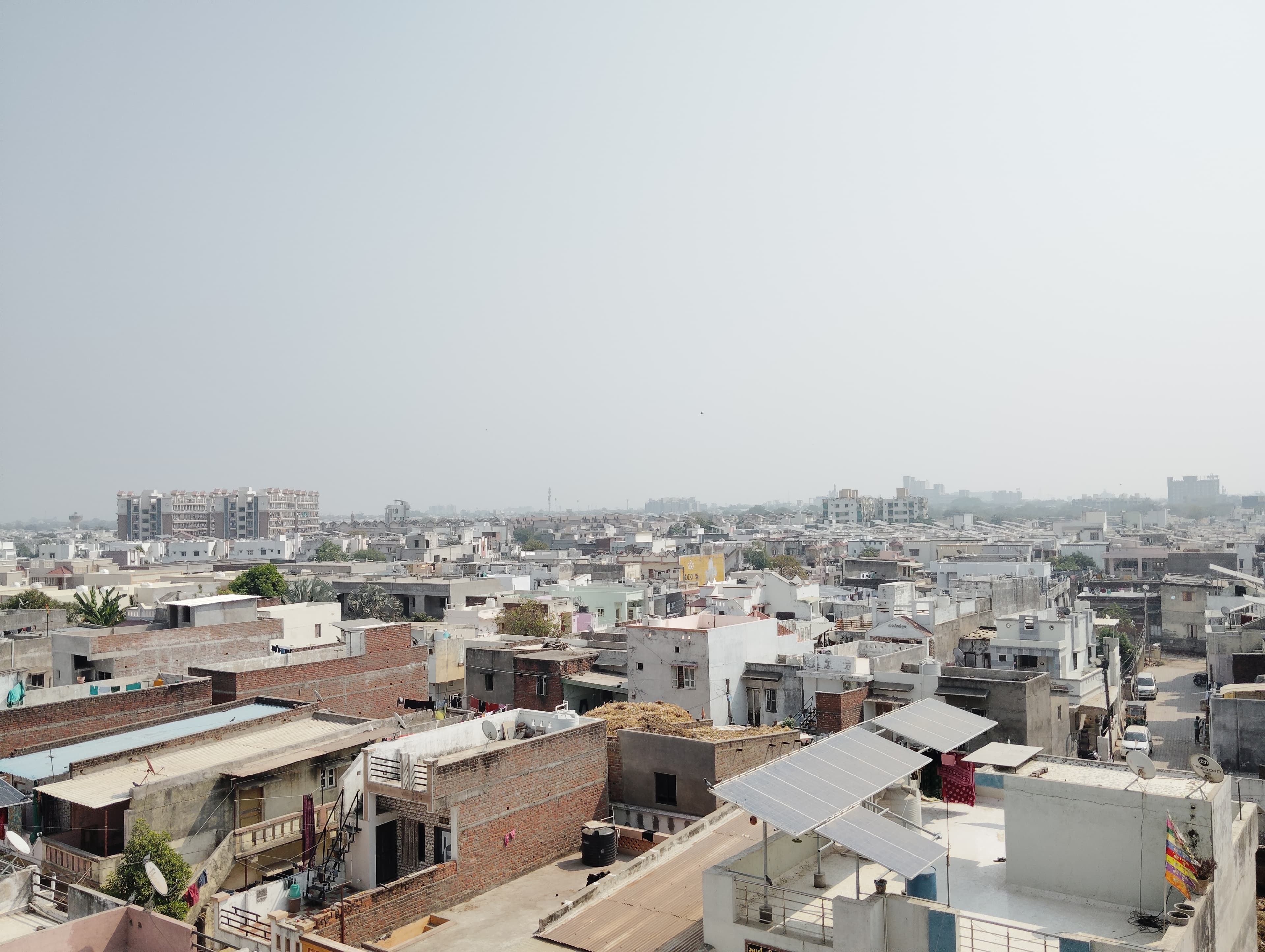 Rooftop solar panels on homes in a residential Indian neighbourhood